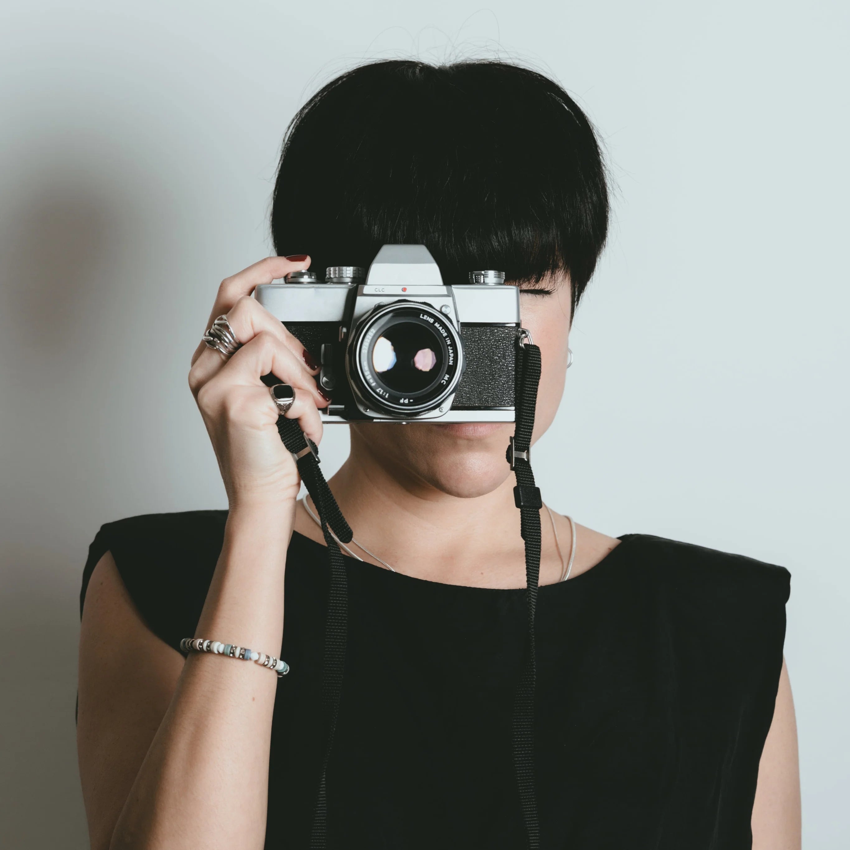files/woman-with-short-dark-hair-takes-a-photo.webp